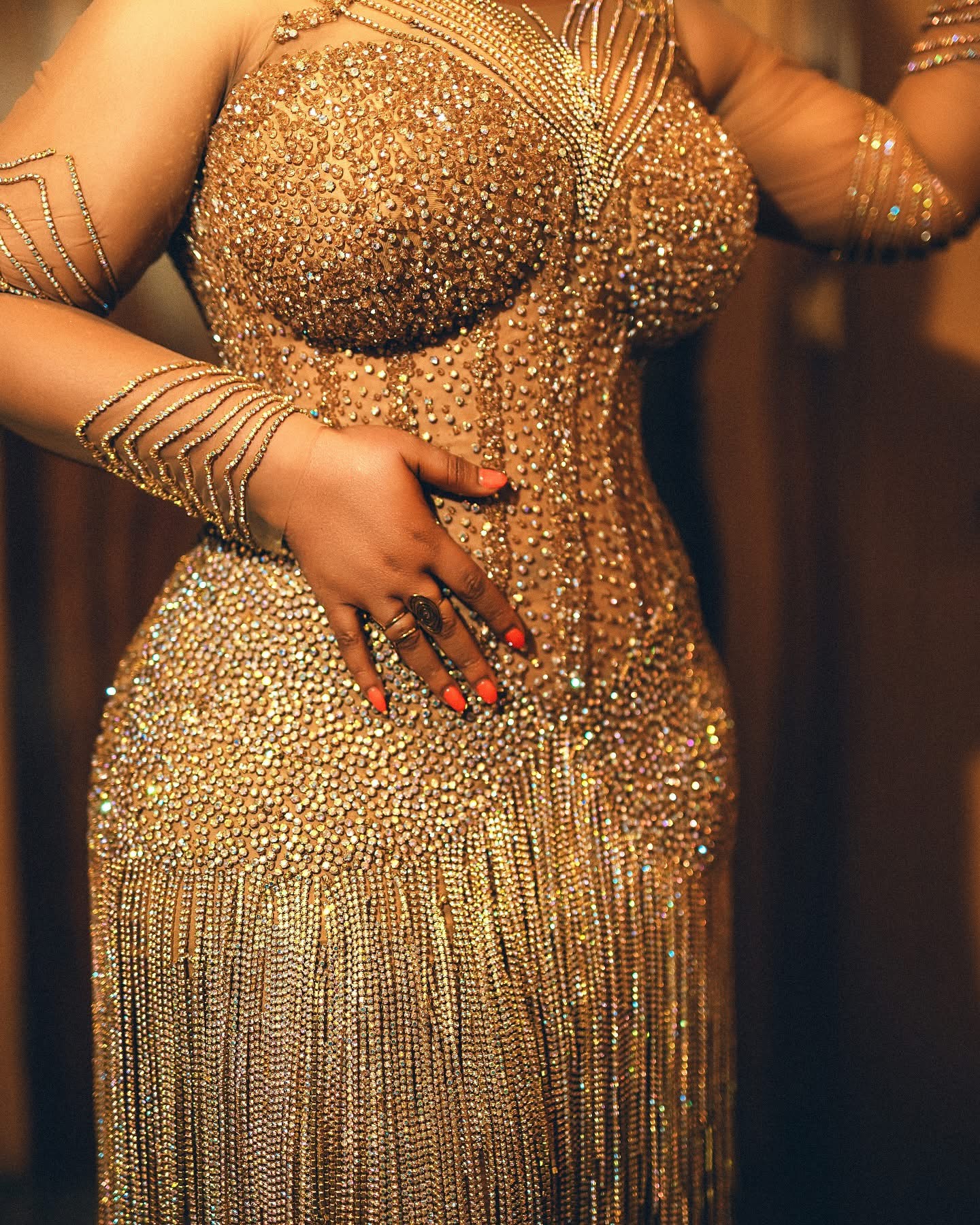 Gold crystal beadwork and fringe close-up detail